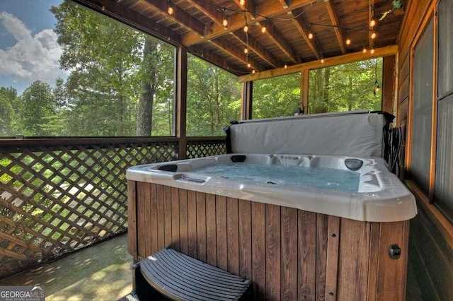 unfurnished sunroom featuring a hot tub