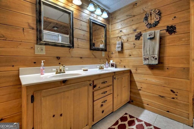 bathroom with wood walls, tile patterned floors, and double sink vanity