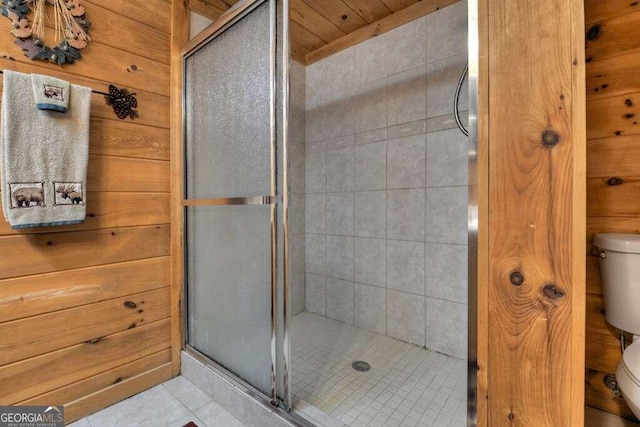 bathroom featuring tile patterned flooring, wood ceiling, toilet, and an enclosed shower