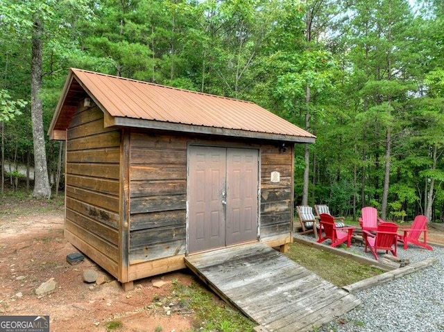 view of outdoor structure with an outdoor fire pit