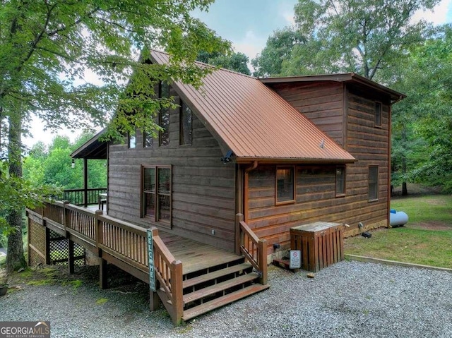 rear view of property with a wooden deck