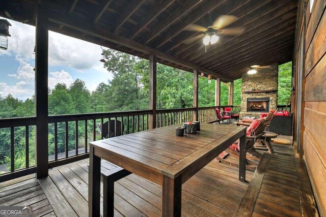 deck featuring an outdoor stone fireplace