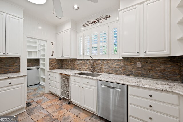 kitchen with sink, backsplash, stainless steel dishwasher, light tile patterned flooring, and ceiling fan