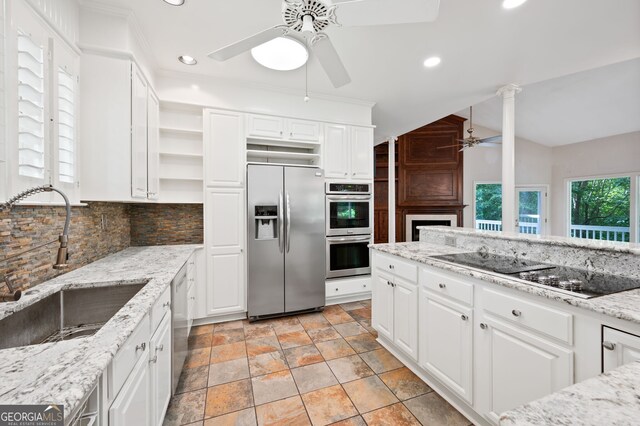 kitchen featuring tasteful backsplash, stainless steel appliances, light stone countertops, light tile patterned flooring, and ceiling fan