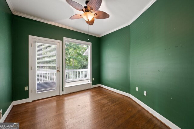 empty room with ornamental molding, hardwood / wood-style floors, and ceiling fan