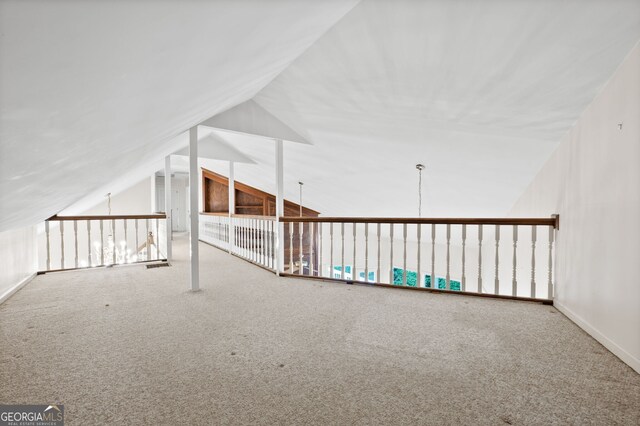 bonus room with lofted ceiling and carpet