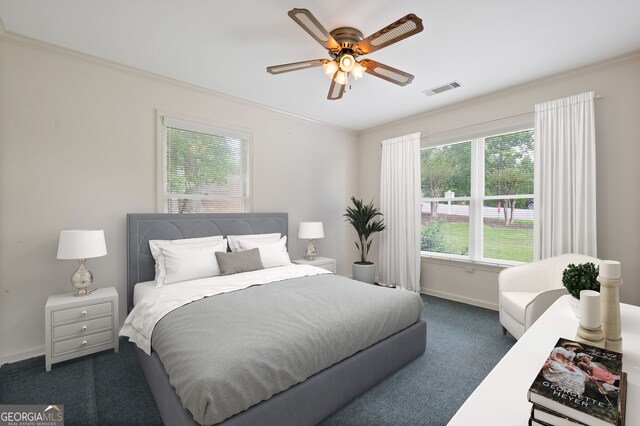 carpeted bedroom with multiple windows, ceiling fan, and crown molding