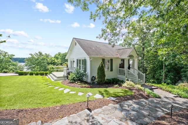 view of side of property with a lawn