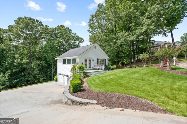 view of front of property featuring a garage and a front lawn