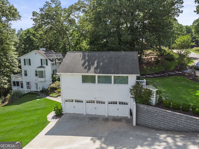 view of front of home with a garage and a front lawn