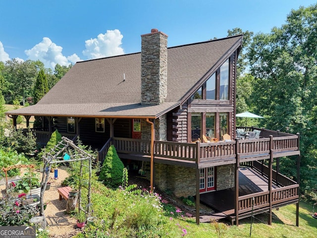 rear view of property with a wooden deck