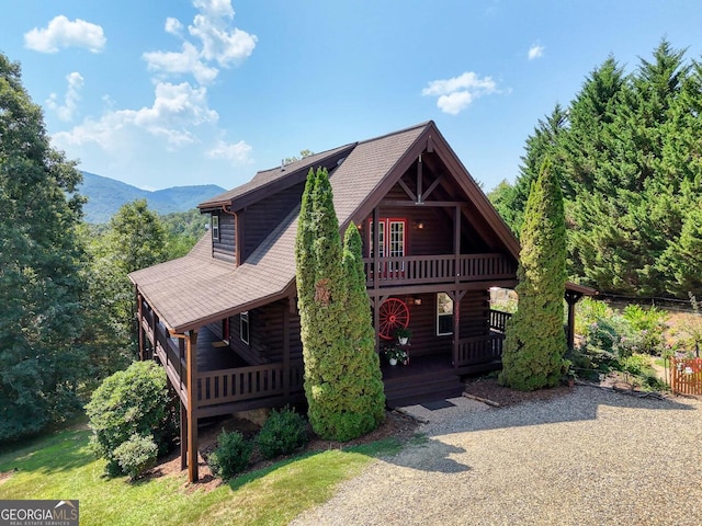 log-style house featuring a deck with mountain view