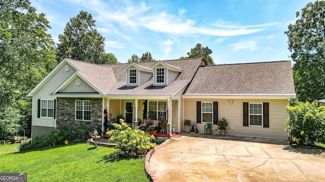 cape cod home with a front yard and covered porch