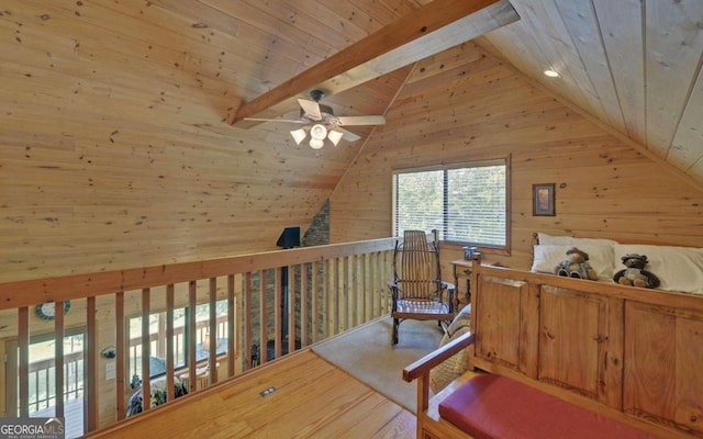 interior space featuring wood walls, high vaulted ceiling, beamed ceiling, and wooden ceiling