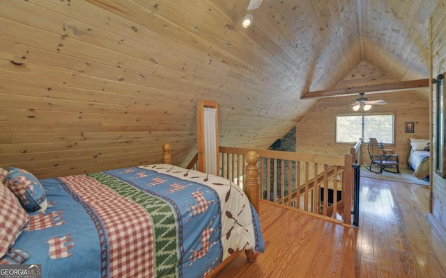 bedroom with wood walls, wooden ceiling, wood-type flooring, and vaulted ceiling