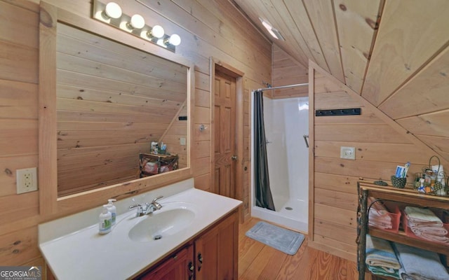 bathroom featuring wood ceiling, wood walls, vaulted ceiling, and walk in shower