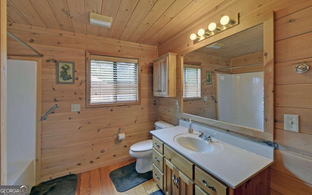 full bathroom with hardwood / wood-style floors, shower / bathing tub combination, toilet, vanity, and wood walls