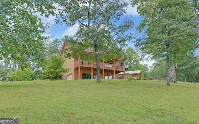 back of property with a deck and a lawn