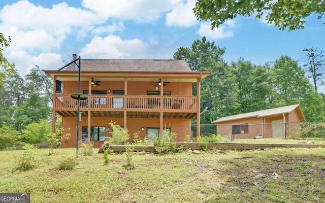 rear view of property featuring a balcony and ceiling fan