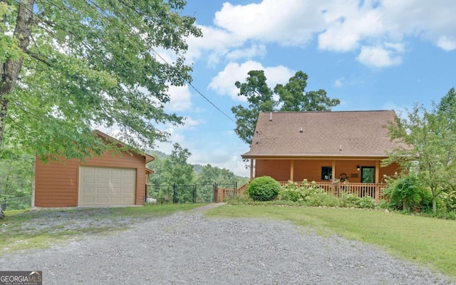 view of property exterior with a garage, covered porch, and an outdoor structure