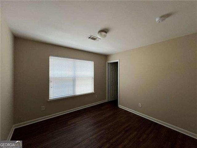 unfurnished room with wood-type flooring