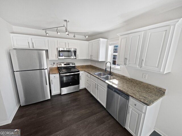608 Summer Pl, Norcross, GA 30071 - kitchen featuring a sink, white cabinetry, dark wood finished floors, baseboards, and appliances with stainless steel finishes