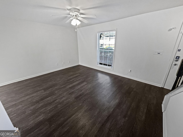 608 Summer Pl, Norcross, GA 30071 - spare room with dark wood-type flooring, a ceiling fan, and baseboards