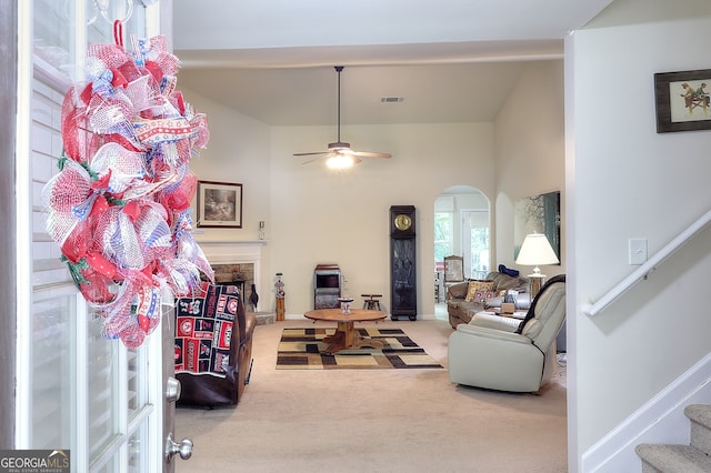 carpeted living room featuring ceiling fan