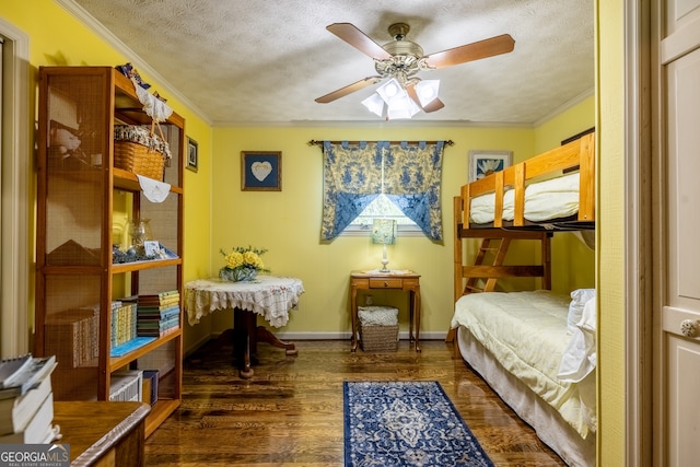 bedroom featuring dark hardwood / wood-style floors, a textured ceiling, crown molding, and ceiling fan