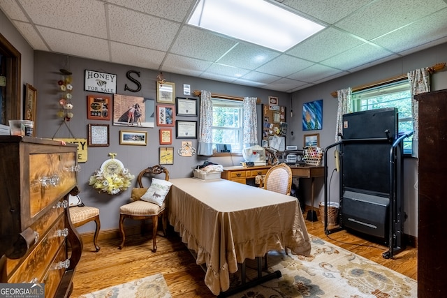 interior space with light hardwood / wood-style floors and a paneled ceiling