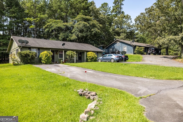 ranch-style home with a front lawn