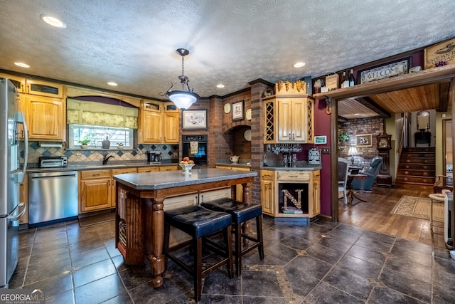 kitchen with appliances with stainless steel finishes, a kitchen island, decorative backsplash, a textured ceiling, and dark wood-type flooring