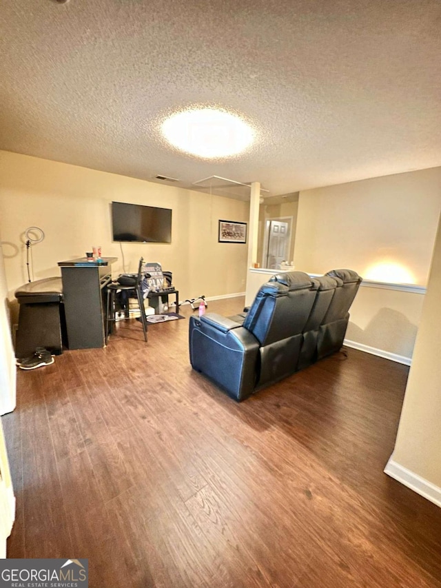 living room with hardwood / wood-style flooring and a textured ceiling