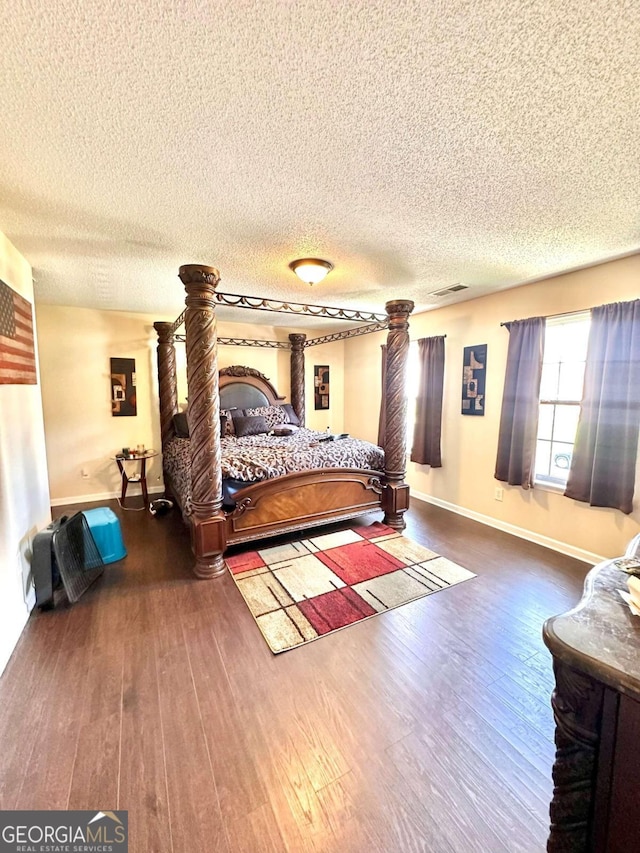 bedroom featuring hardwood / wood-style flooring and a textured ceiling