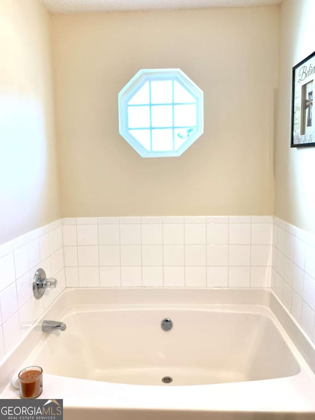 bathroom with a tub