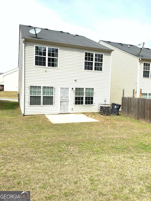 rear view of house with a patio area and a yard