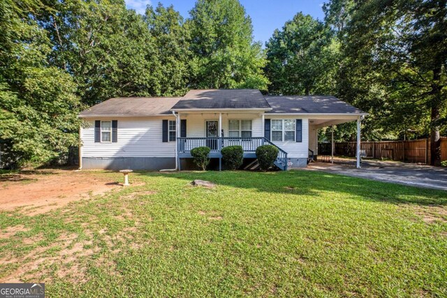 single story home featuring covered porch, a carport, and a front yard