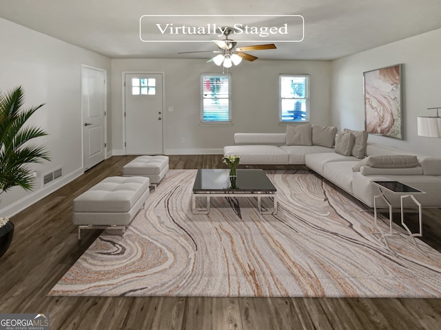 living room with plenty of natural light, dark hardwood / wood-style floors, and ceiling fan