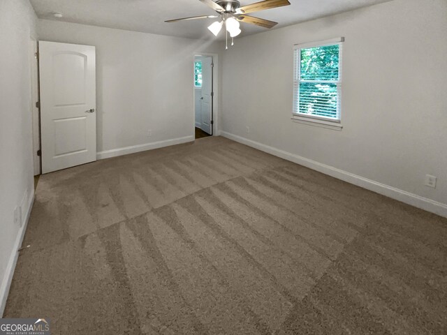 spare room with carpet and ceiling fan