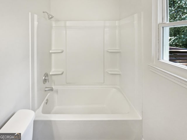 bathroom with shower / bath combination, toilet, and a healthy amount of sunlight