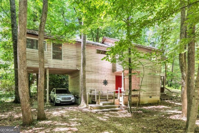 rear view of house featuring a carport