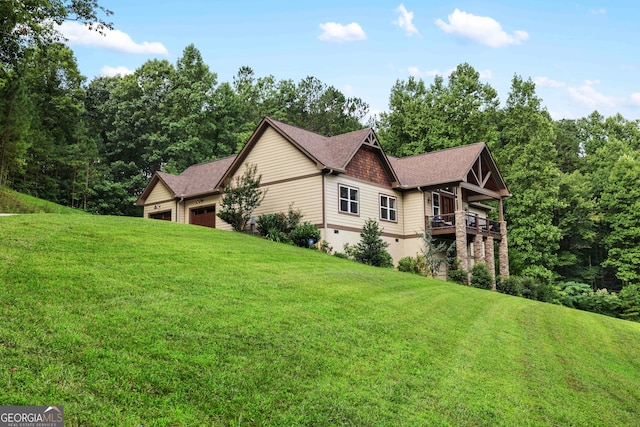 view of side of home with a lawn