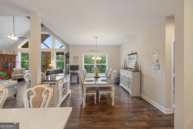 dining space with dark wood-type flooring, ceiling fan with notable chandelier, and lofted ceiling