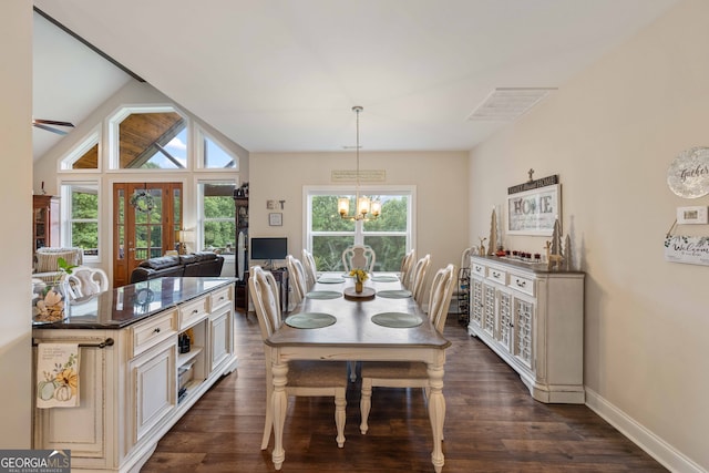 dining room with vaulted ceiling, dark hardwood / wood-style floors, and a chandelier