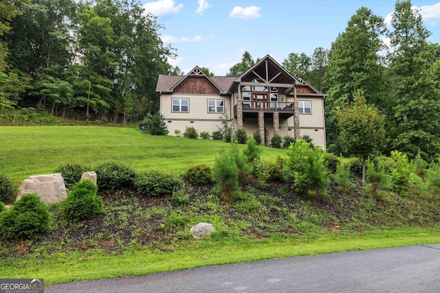 view of front of property with a deck and a front yard