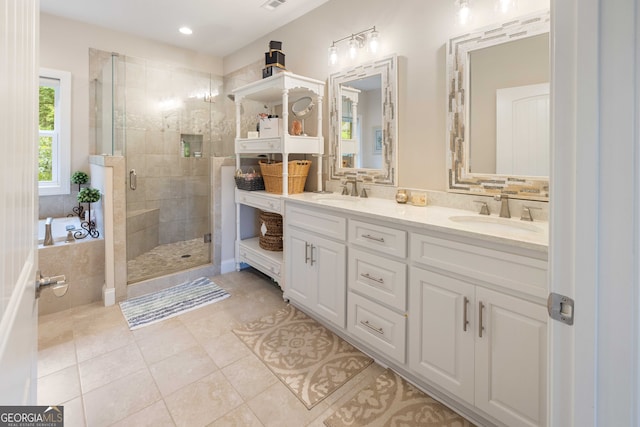 bathroom with a shower with shower door, tile patterned floors, and double vanity