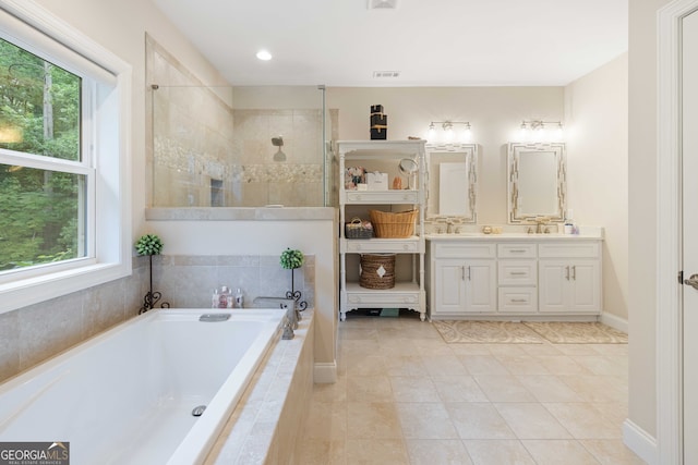 bathroom featuring dual vanity, a wealth of natural light, and tile patterned flooring