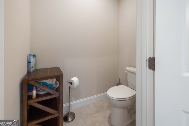 bathroom with tile patterned floors and toilet