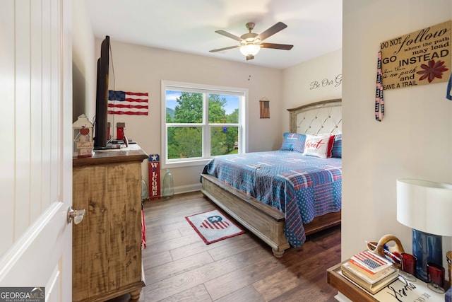 bedroom with wood-type flooring and ceiling fan