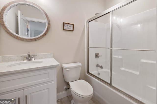 full bathroom featuring bath / shower combo with glass door, tile patterned floors, toilet, and vanity